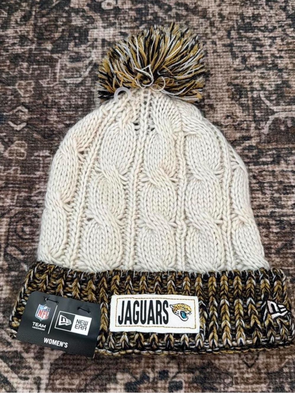 New Era Women's Jaguars Cream Cable Knit Pom Beanie with Black & Gold Trim
